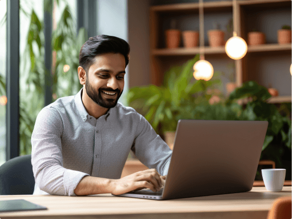 man typing on laptop in coffee shop